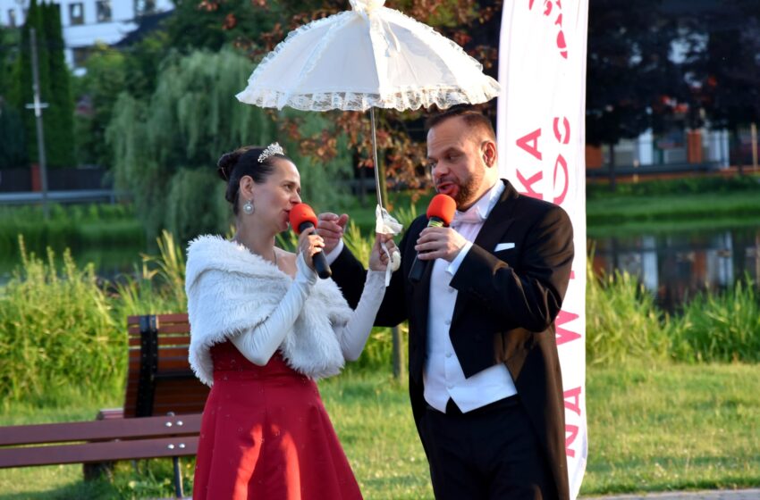 śpiewak i śpiewaczka pod parasolem